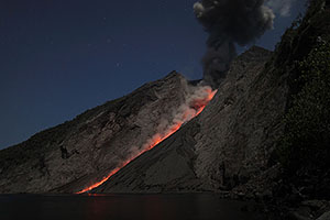 Nighttime eruption producing ash cloud, Batu Tara volcano, Indonesia