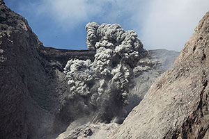 Explosive eruption producing dense ash cloud and volcanic bombs, Batu Tara volcano, Indonesia