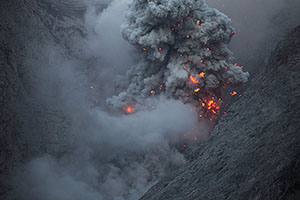 Glowing volcanic bombs at dusk, Batu Tara volcano