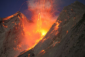 Nighttime explosive eruption producing dense hail of volcanic bombs, Batu Tara volcano, Indonesia
