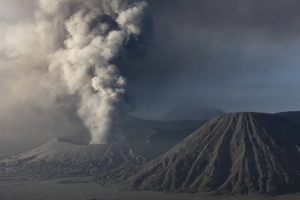 Eruption Mount Bromo Volcano, Tengger Caldera, 2010-2011 ash cloud, Batok cone in foreground