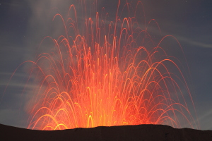 Strombolian eruption at night. Parabolic paths of bombs, Mount Bromo Volcano