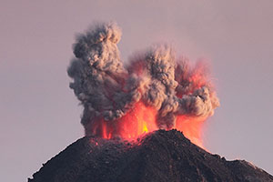 Powerful eruption of Fuego de Colima volcano throws red glowing rocks and ash into air