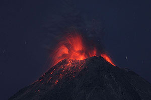 Nighttime eruption with lava bombs hitting flank, Fuego de Colima volcano, Mexico