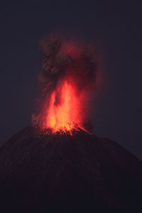 Powerful strombolian / vulcanian nighttime eruption throwing glowing lava high in air, Fuego de Colima volcano, Mexico