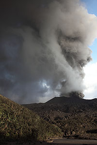 Dukono volcano, ash and meteorological clouds mixing, portrait orientation