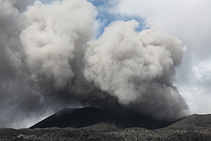 Wind swirly steam and ash cloud from Dukono volcano