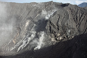 Crater of Dukono volcano, fumaroles on inner crater wall