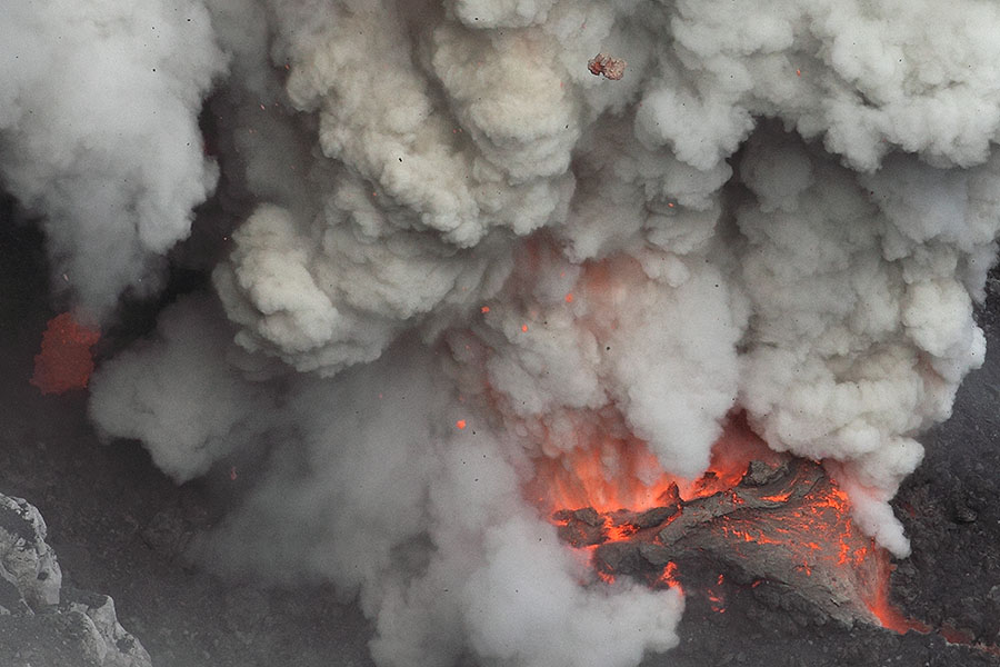 Amazing detail of glowing lava, flying bombs and gas jets at erupting vent of Dukono volcano