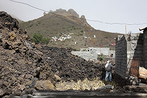 Lava flow with hillside evacuees behind, Portela settlement, Fogo volcano