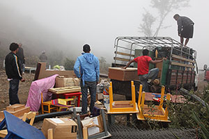 Loading belongings onto lorries outside Portela, Fogo volcano, 2014