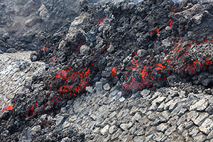 Lava cascading over road embankment, Fogo Volcano, 2014
