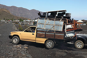 Family evacuating with belongings on truck from Portela, Fogo Eruption 2014