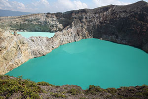 Kelimutu volcano, colourful crater lakes in bright sunlight, green, turqoise, Flores, Indonesia