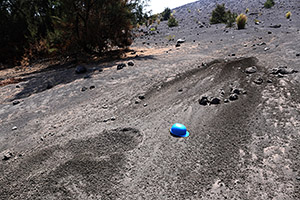 Fresh impact craters of volcanic bombs from Anak Krakatau, helmet for scale