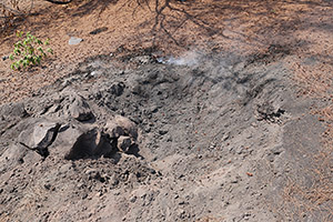 Hot volcanic bomb in smouldering impact crater, Anak Krakatau