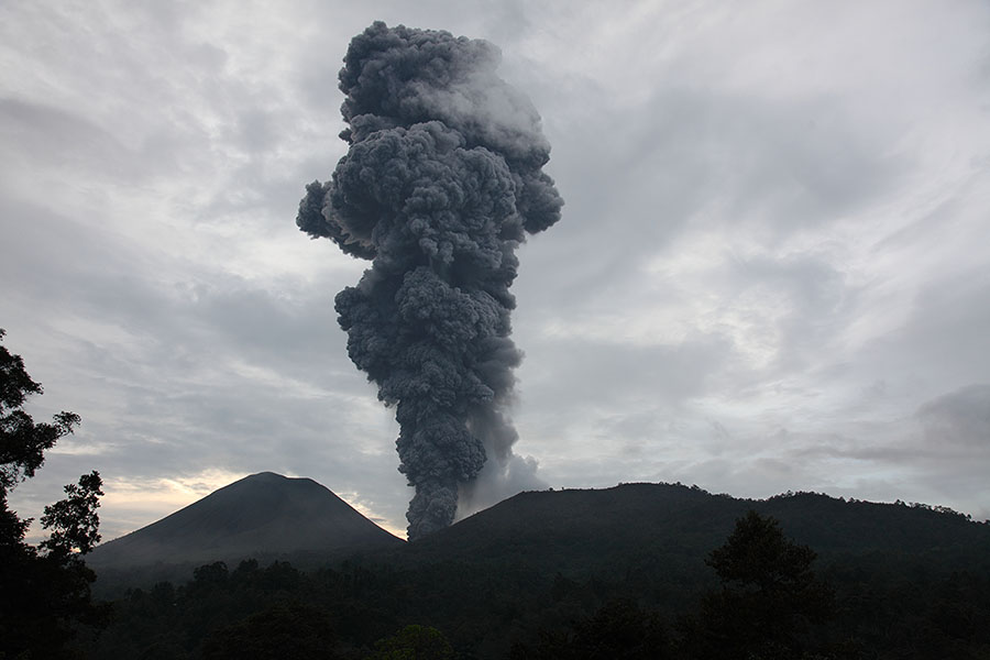 Ash cloud from vulcanian eruption of Lokon-Empung Volcano's Kawah Tempaluan crater viewed at dusk
