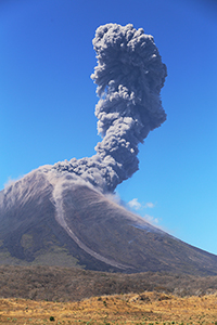 Portrait orientation image of Momotombo volcano erupting