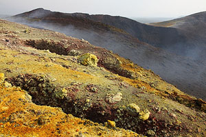 Nyamuragira Volcano primary site of 2011/2012 eruption. Fissures, sulphurous yellow fumarolic deposits with inactive crater behind