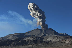 Ash cloud from Sabancaya Volcano rises into clear blue sky