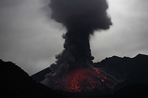 Mushroom cloud and glowing flanks at night following eruption of Sakurajima volcano