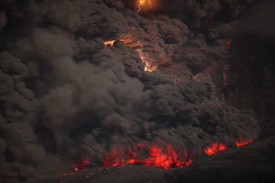 Nighttime pyroclastic flow with lightning, Sinabung volcano, 2014